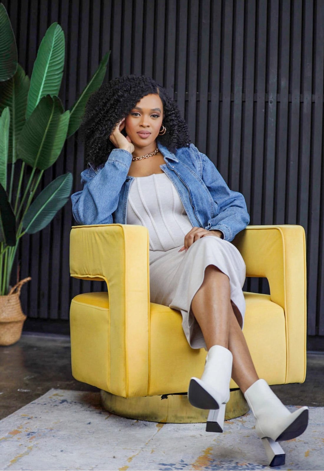 Imani, founder of Exalt The Light, seated in a golden velvet chair